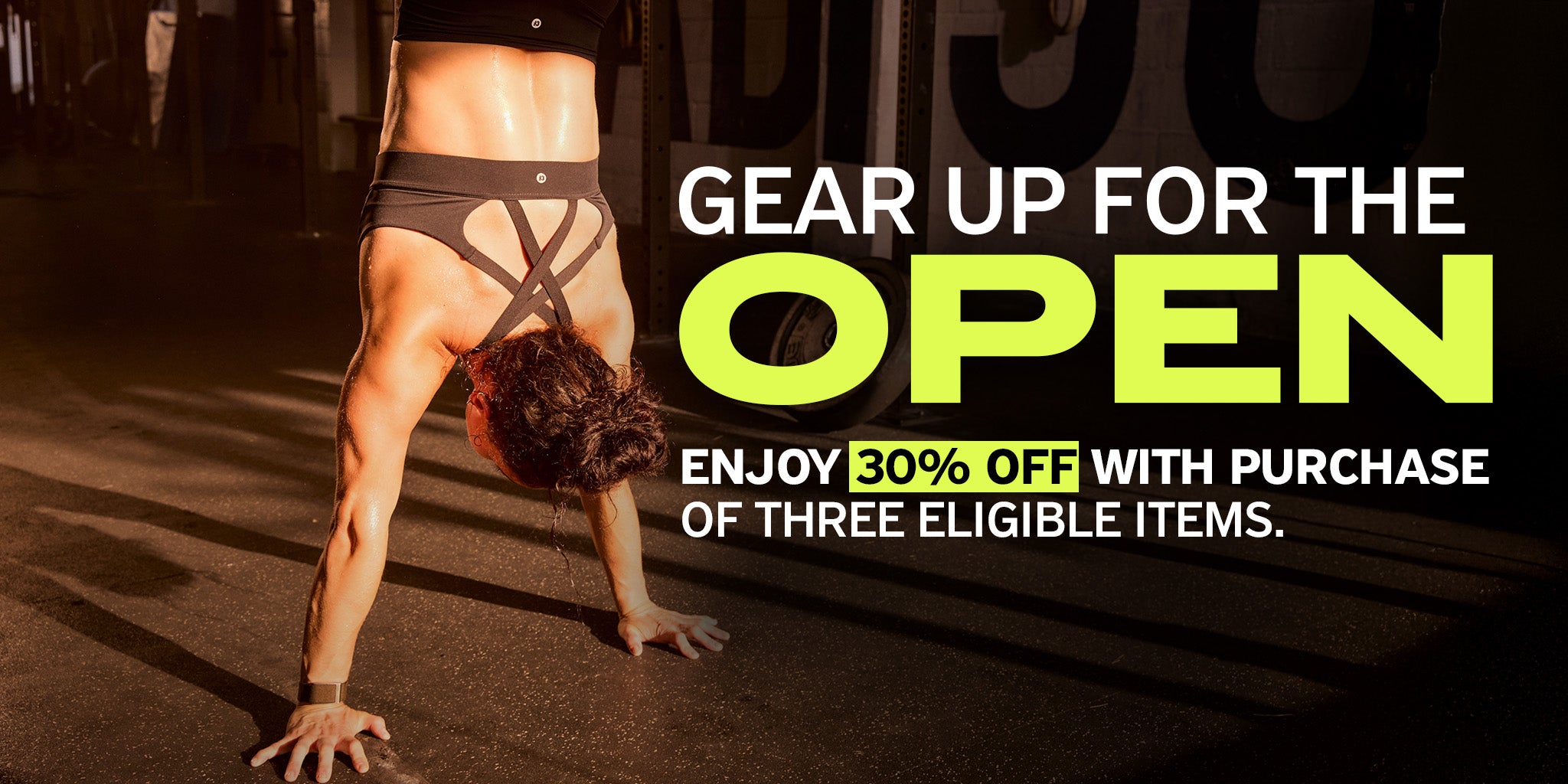 Woman wearing CrossFit apparel doing handstand with text "GEAR UP FOR THE OPEN ENJOY 30% OFF WITH PURCHASE OF THREE ELIGIBLE ITEMS"